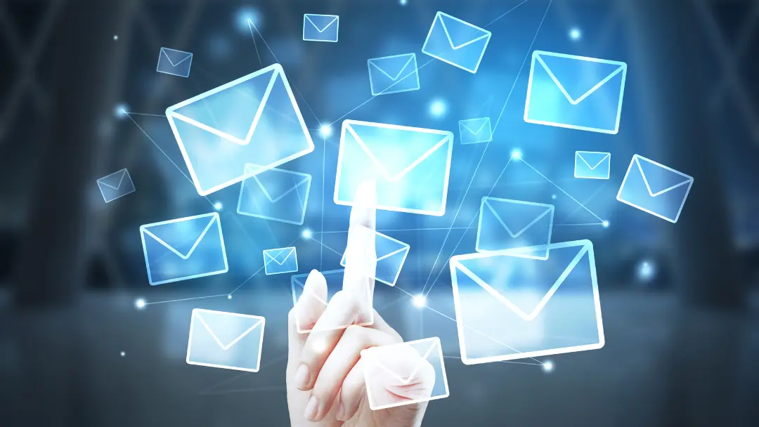 finger pointing to an email with multiple emails surrounding it
