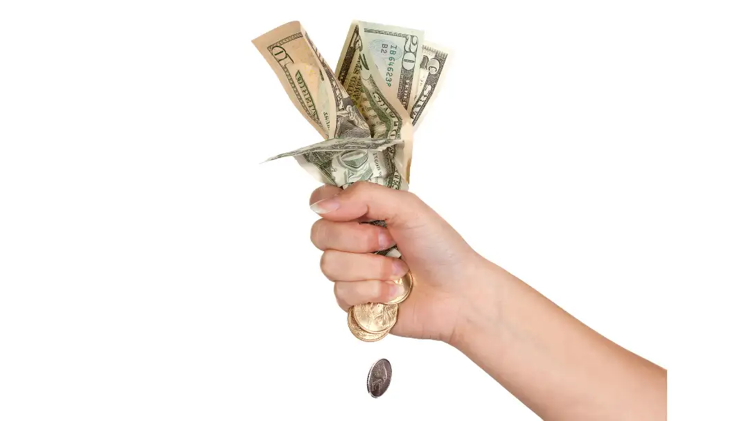 woman fist squeezing money