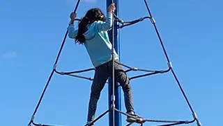 young girl climbing ropes
